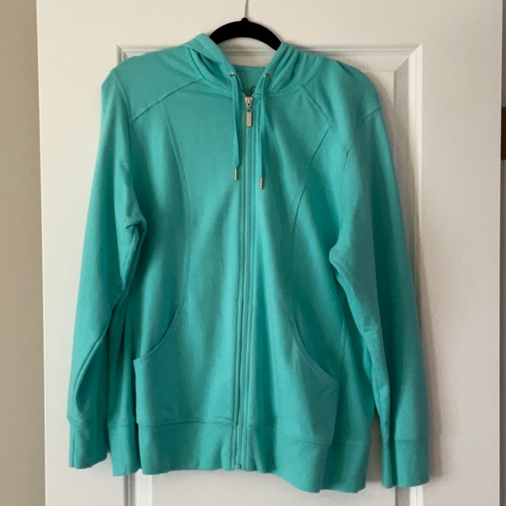 Light teal zipper up hooded sweatshirt.
